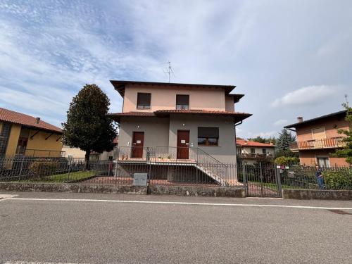 a house with a fence in front of a street at Casette Airport AGATA in Seriate