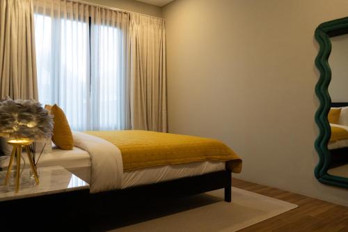 a bedroom with a bed with a window at Serenity Luxury Smart Villas with Private Pool, Canggu in Dalung