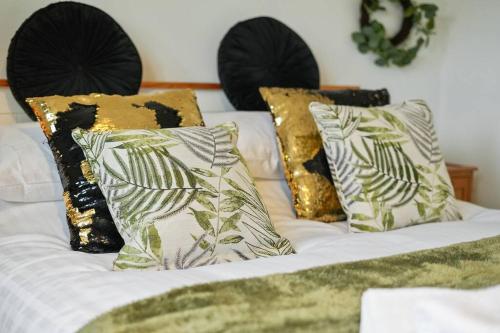 a white bed with three pillows on it at North Lincs Cosy Home in Messingham