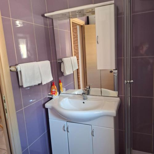 a bathroom with a sink and a mirror at Jelly in Crikvenica