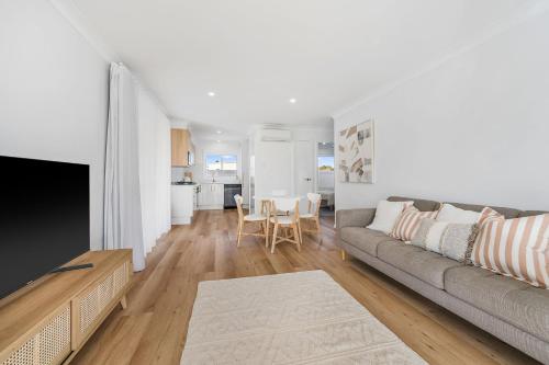 a living room with a couch and a table at Frazers Creek Escape