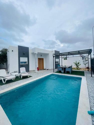 a pool in front of a house at Ilef in Midoun