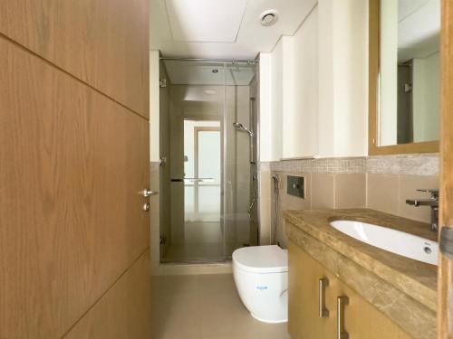 a bathroom with a sink and a toilet at Private Sea View Room in 3BR Downtown Apartment Direct Mall & Metro Access in Dubai