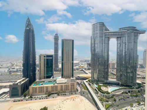 a group of tall buildings in a city at Private Sea View Room in 3BR Downtown Apartment Direct Mall & Metro Access in Dubai