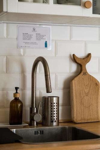 a kitchen counter with a sink and a cutting board at Cozy home with jacuzzi - near the airport in Ponta Delgada