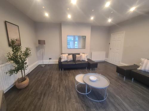 a living room with a couch and a table at AA Exec Apartments in South Shields