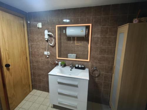 a bathroom with a sink and a mirror at Apartamentos Sierra Nevada Pradollano 3000 in Sierra Nevada
