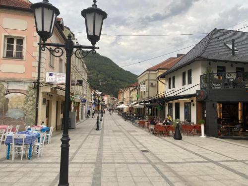 an empty street with tables and chairs in a town at Kuca za odmor Lola in Ivanjica