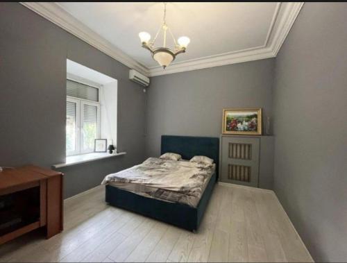a bedroom with a bed and a window and a chandelier at Good driams Xoctel in Kyiv