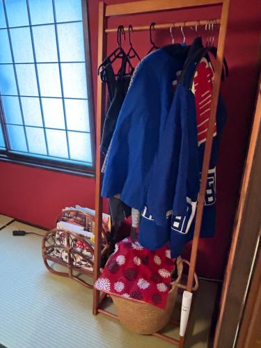 a closet with a blue shirt and a basket at sukeemon in Biei