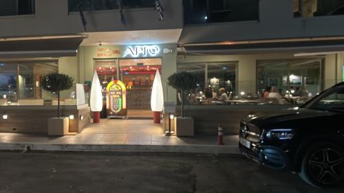 a car parked in front of a restaurant at night at Argo Suites in Póros Kefalonias