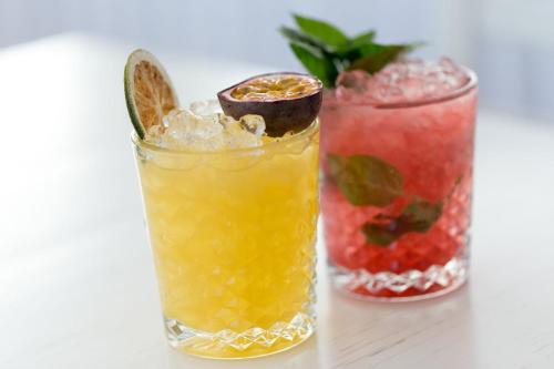 two cocktails sitting on top of a table at Ibiscus Boutique in Mýkonos City