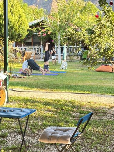 a park with people doing yoga in the grass at ŞAH apart in Kemer