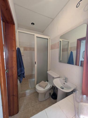 a bathroom with a toilet and a sink at Gozitan Charm in Xaghra with Pool in Xagħra