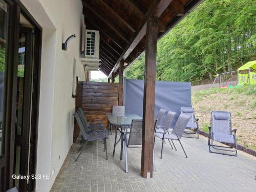 a table and chairs sitting on a patio at Kaszuby Punkt Klonowo Przywidz sauna klima basen in Przywidz