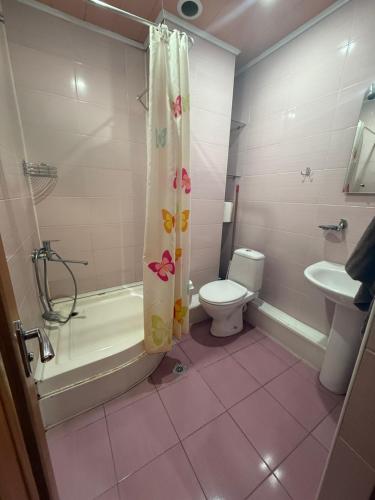 a bathroom with a tub and a toilet and a shower at Republiq Square Buzand 7 street in Yerevan