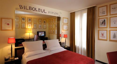 a hotel room with a bed and a large mirror at Phi Hotel Bologna in Bologna