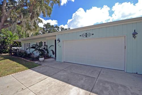 a house with a white garage with a driveway at Edgemere in Siesta Key