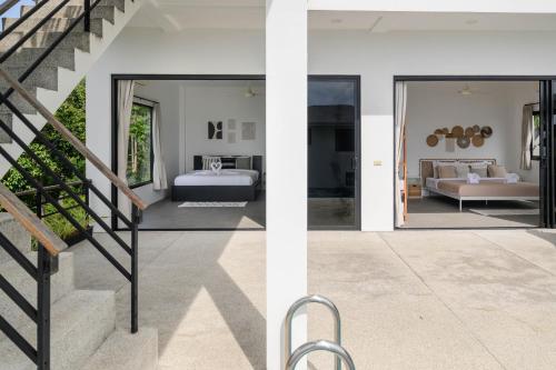 two views of a house with a bedroom and a staircase at Sunset villa rooftop with pool 180 Seaview in Koh Phangan