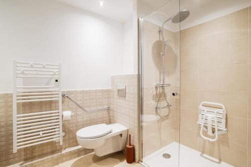 a bathroom with a toilet and a glass shower at Setclub Hôtel & Spa Aix-en-Provence in Aix-en-Provence