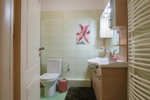 a bathroom with a toilet and a sink at Kompitsi View Retreat in Kompítsion