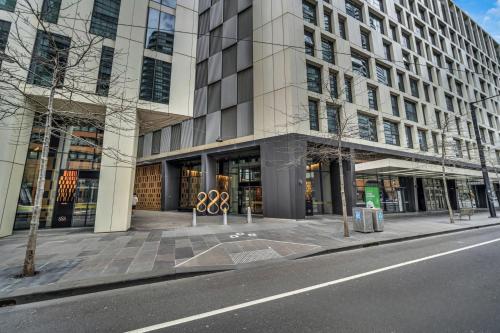 a building on a street in front of a building at Docklands Harbour & City Views Pool, Free Onsite Parking , Yoga & Gym in Melbourne