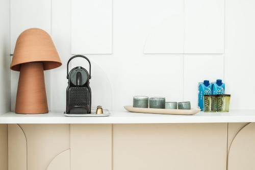 a shelf with a lamp and other items on it at Setclub Hôtel & Spa Aix-en-Provence in Aix-en-Provence