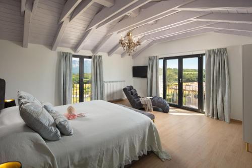 a bedroom with a bed with a child sitting on it at Villa Roti by Rent Istria in Kostrčani