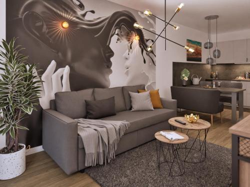 a living room with a couch and a kitchen at Ferienwohnung Sonnenufer Residenz am See in Neuruppin in Neuruppin