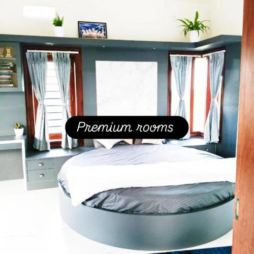 a circular bed in a room with windows at Green Glow Homestay in Chikmagalūr