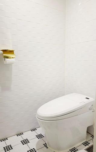 a white bathroom with a toilet in a room at Signature Tourist Hotel in Seoul
