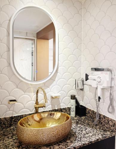 a bathroom with a sink and a mirror at Signature Tourist Hotel in Seoul