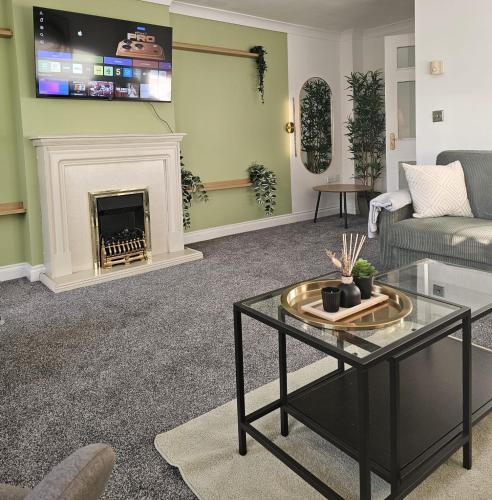 a living room with a couch and a fireplace at Stunning Contractor home, Company workers WLC, Netflix in Sandal and Walton