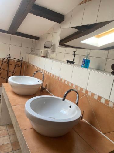 a bathroom with two sinks on a counter at Ferienhaus an der Ostsee mit großem Garten in Rerik