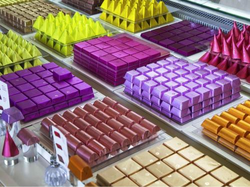 a display of different colored boxes in a store at La Cigale Hotel Managed by Accor in Doha