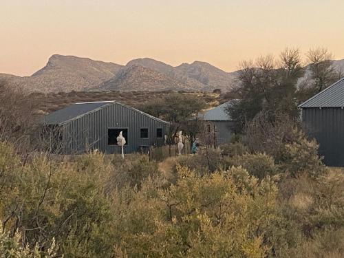 a group of people standing in front of a barn at Savanna Villas in Windhoek
