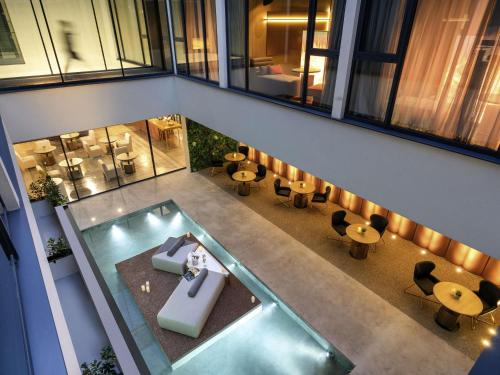 an overhead view of a building with a swimming pool at The Emporium Hotel Plovdiv - MGallery Collection in Plovdiv