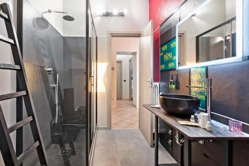 a bathroom with a sink and a glass shower at Mema Holiday Home in Aosta