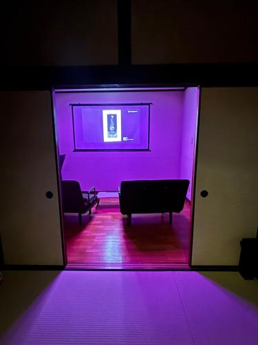 a room with a purple light projected on the wall at 天宿りAmayadori in Ise