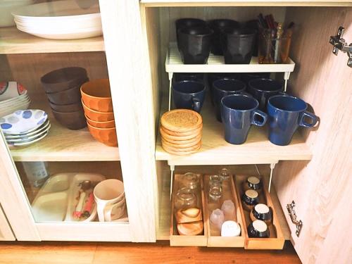 a cupboard filled with lots of pots and pans at 天宿りAmayadori in Ise