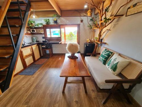 a living room with a couch and a table at TỊNH Retreat Phu Quoc in Phu Quoc