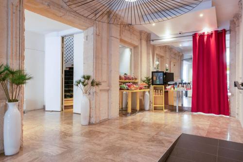 a large room with a red curtain and a table at Hotel Astoria - Astotel in Paris