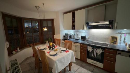 a kitchen with a table with a white table cloth at Gabriel in Sankt Augustin