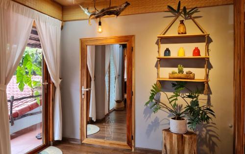 a room with a hallway with a door and a plant at TỊNH Retreat Phu Quoc in Phu Quoc