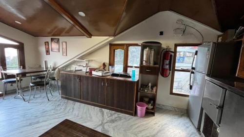 Una cocina y un comedor de una casa con refrigerador en Swastik Inn, en Jāmb