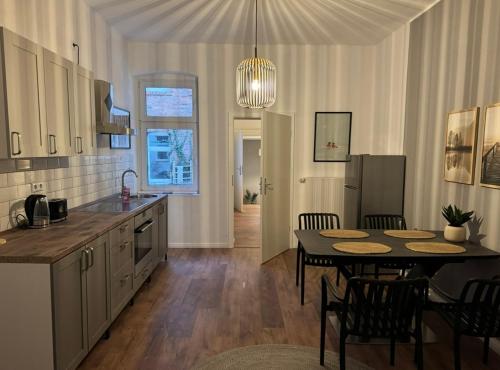 a kitchen and dining room with a table and chairs at Appartement "Hans" in Köthen mit 4 Schlafzimmern in Köthen