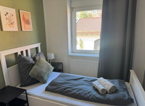 a bedroom with a bed with two towels on it at Ferienhaus "Anita" in Eisleben mit 3 Schlafzimmern in Lutherstadt Eisleben