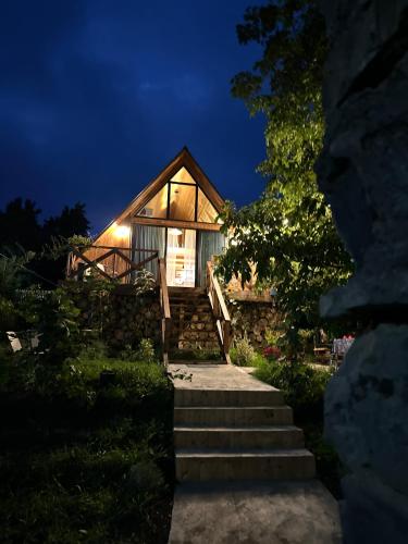 a house at night with stairs leading up to it at Tasia's Cottage in Tsalka