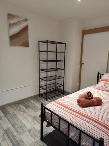 a bedroom with a bed with a towel on it at Appartement 2 Ch Zegerscappel in Zeggers-Cappel