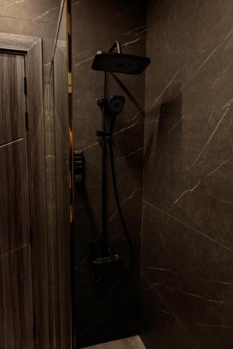 a shower in a bathroom with a shower head at Palazzo hotel in Kuwait